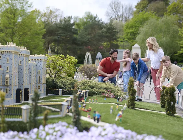 A family looking at Miniland in the sun