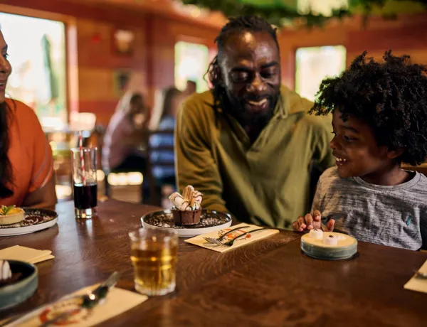 Family eating dessert at the LEGOLAND Woodland Village Clubhouse Restaurant & Bar