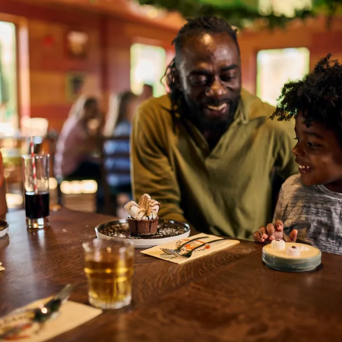 Family eating dessert at the LEGOLAND Woodland Village Clubhouse Restaurant & Bar