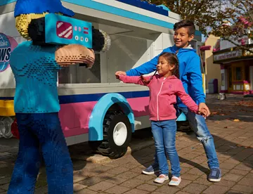 Children posing with LEGO camera man in Heartlake City
