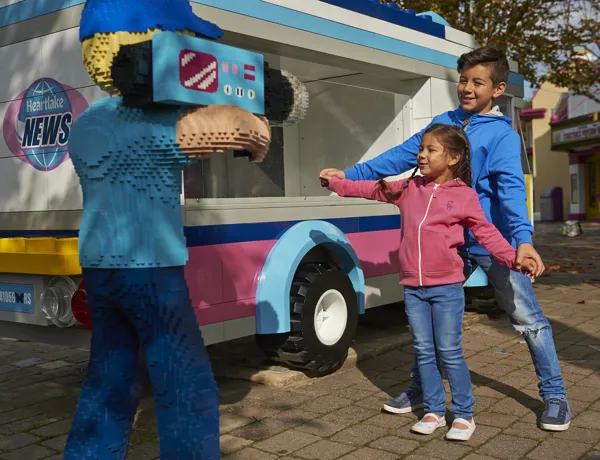 Children posing with LEGO camera man in Heartlake City