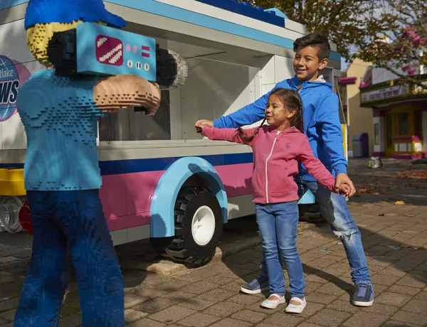 Children posing with LEGO camera man in Heartlake City