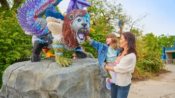 Mother and daughter looking at LEGO model of a Chimera