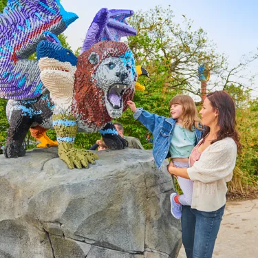 Mother and daughter looking at LEGO model of a Chimera