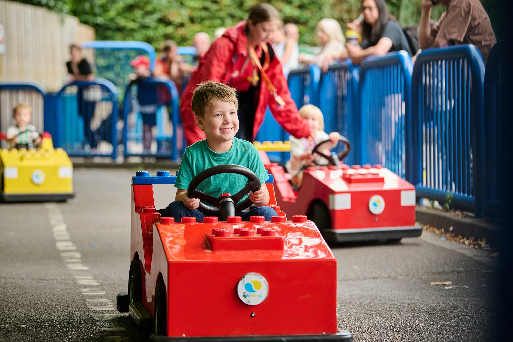 Boy Smiling Driving Red L Drivers Car