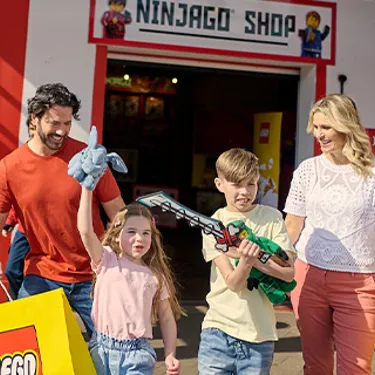 Family with LEGO NINJAGO toys outside of the LEGO NINJAGO Shop