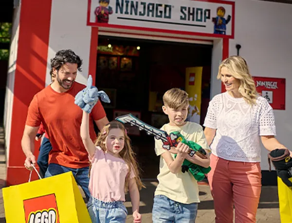 Family with LEGO NINJAGO toys outside of the LEGO NINJAGO Shop