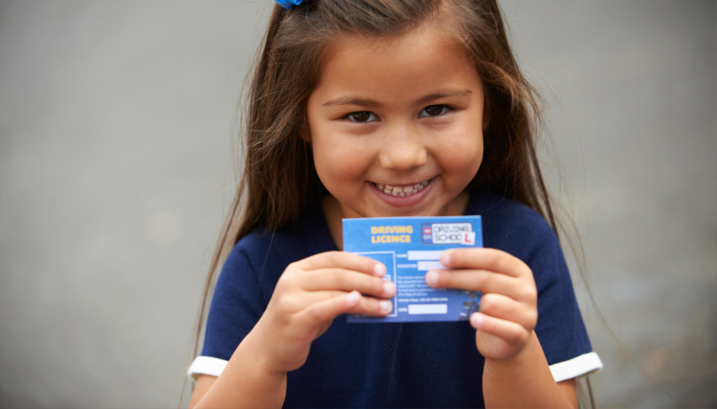 Girl smiling with Driving License at L-Drivers at the LEGOLAND Windsor Resort