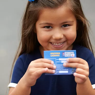 Girl smiling with Driving License at L-Drivers at the LEGOLAND Windsor Resort