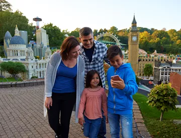 Family using LEGOLAND app in Miniland at the LEGOLAND Windsor Resort