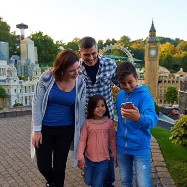 Family using LEGOLAND app in Miniland at the LEGOLAND Windsor Resort