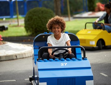 Boy driving car at LEGO® City Driving School at LEGOLAND® Windsor Resort