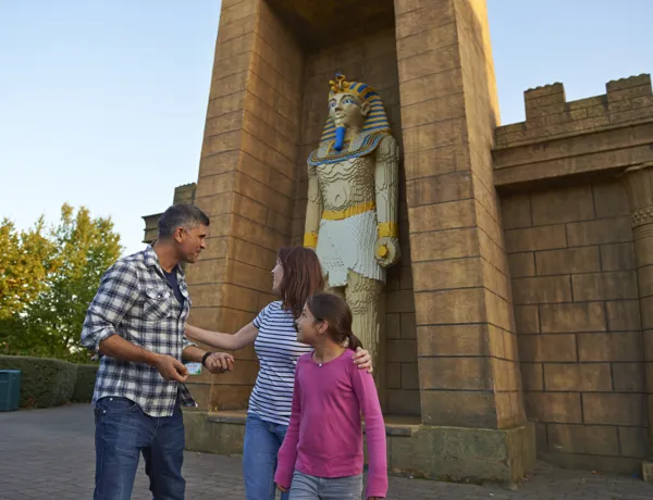 Family next to large Pharaoh model in Kingdom of the Pharaohs