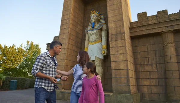 Family next to large Pharaoh model in Kingdom of the Pharaohs