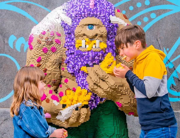 Children eating Fish & Chips next to LEGO Troll at The Hungry Troll