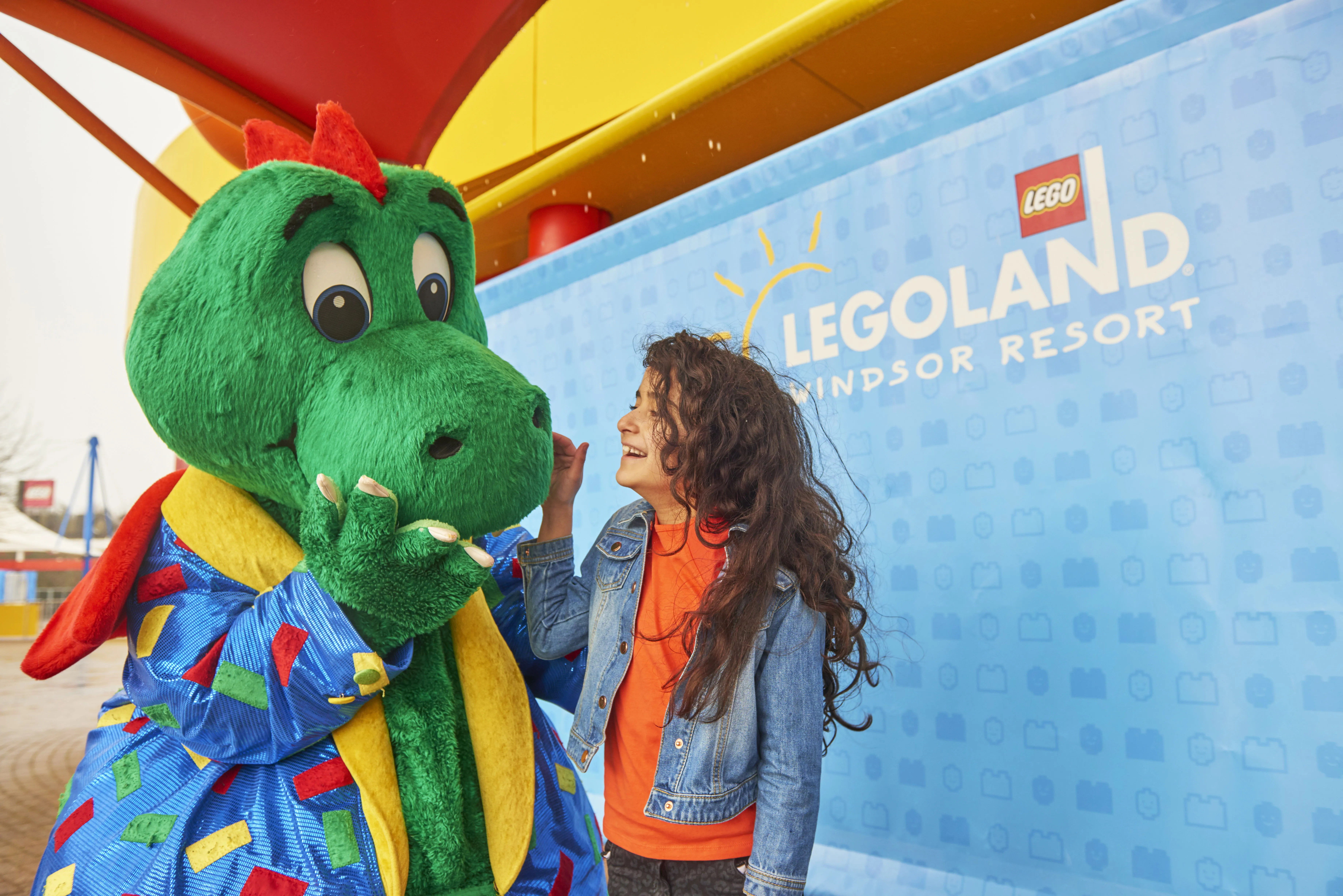 Girl laughing with Ollie the Dragon at the LEGOLAND Windsor Resort