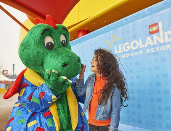 Girl laughing with Ollie the Dragon at the LEGOLAND Windsor Resort
