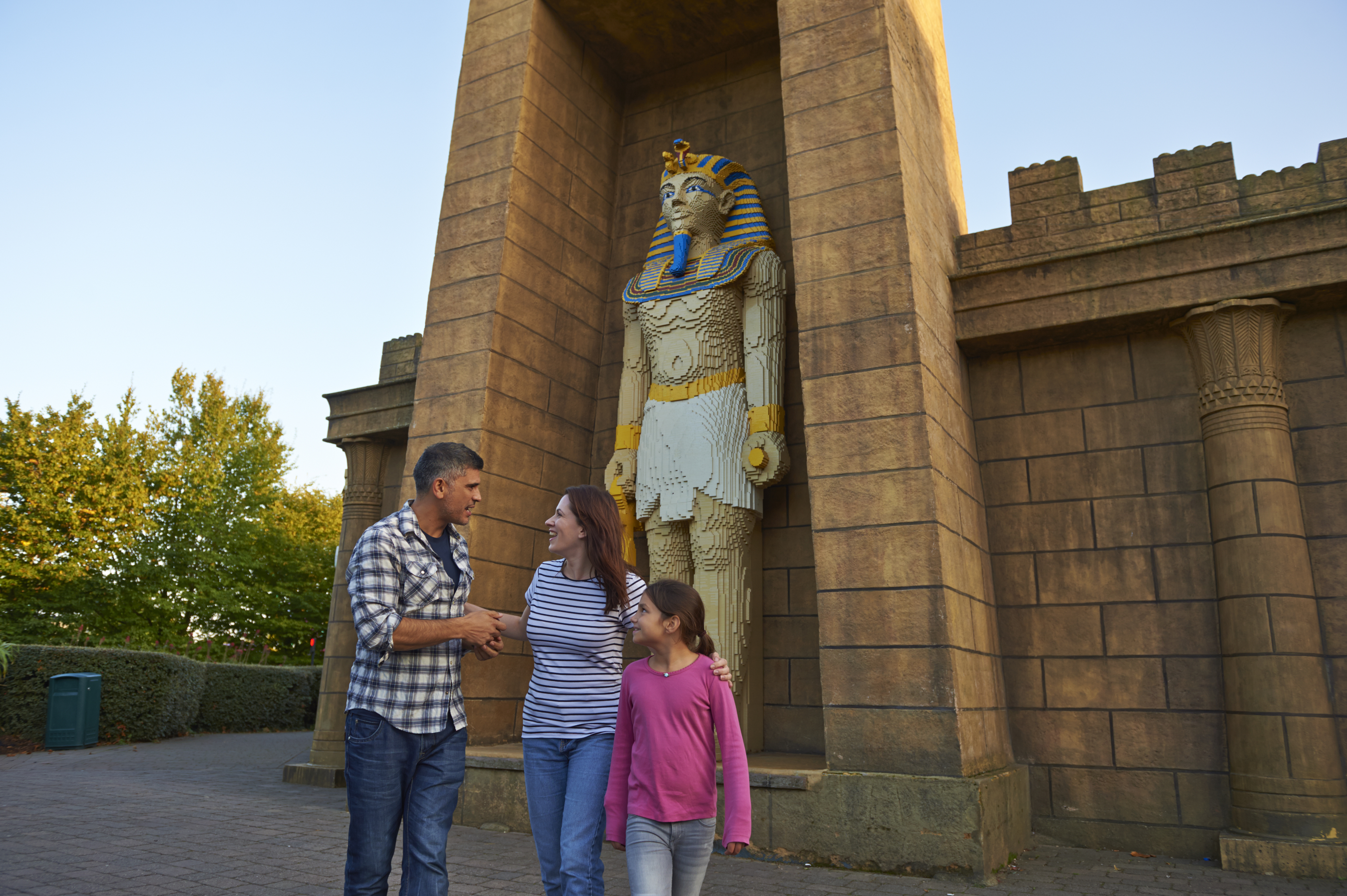 Family next to large Pharaoh model in Kingdom of the Pharaohs