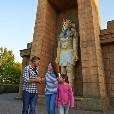 Family next to large Pharaoh model in Kingdom of the Pharaohs