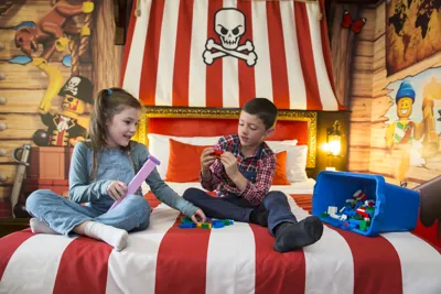 Kids playing with LEGO in a Pirate Room at the LEGOLAND Resort Hotel