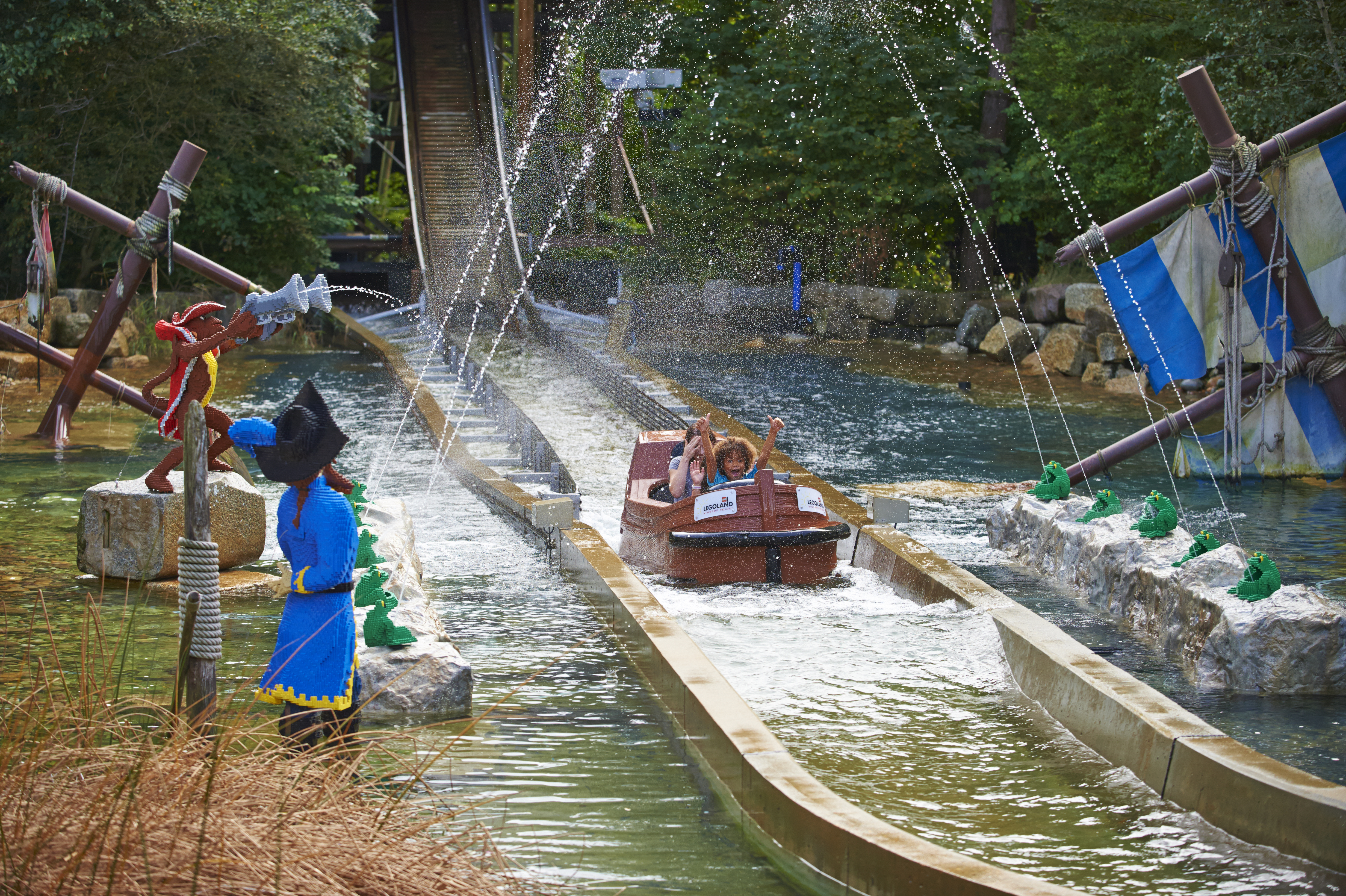 Family getting soaked on Pirate Falls log flume at the LEGOLAND® Windsor Resort