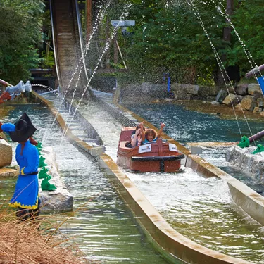 Family getting soaked on Pirate Falls log flume at the LEGOLAND® Windsor Resort