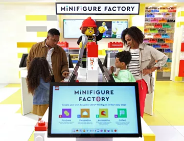 Family building Minifigures at the Minifigure Factory at The LEGO Store