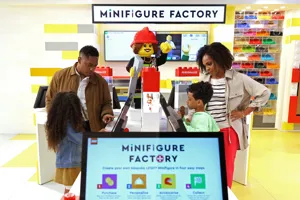 Family building Minifigures at the Minifigure Factory at The LEGO Store