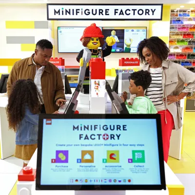 Family building Minifigures at the Minifigure Factory at The LEGO Store