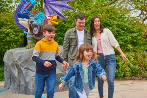 Family in front of LEGO Chimera model