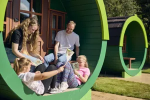 Family sat outside Woodland Village barrel