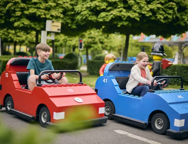 Boy and Girl driving LEGO cars at LEGO City Driving School