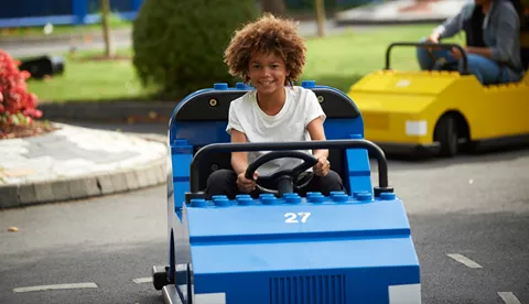 Boy driving car at LEGO® City Driving School at LEGOLAND® Windsor Resort