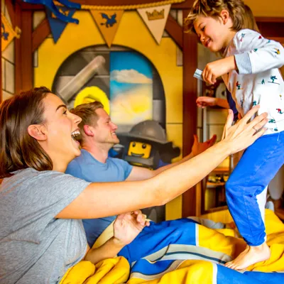 Children bouncing on bed in Knight's Room at LEGOLAND Castle Hotel