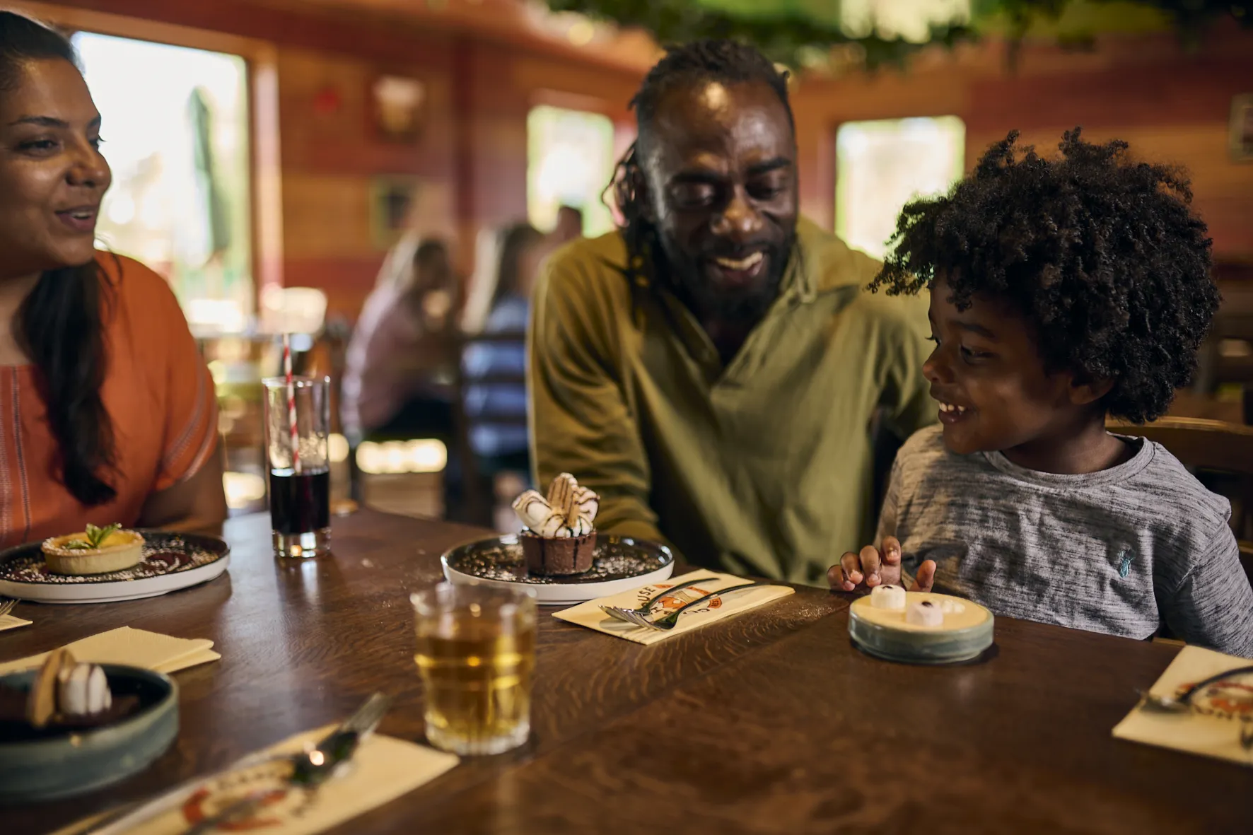 Family eating dessert at the LEGOLAND Woodland Village Clubhouse Restaurant & Bar