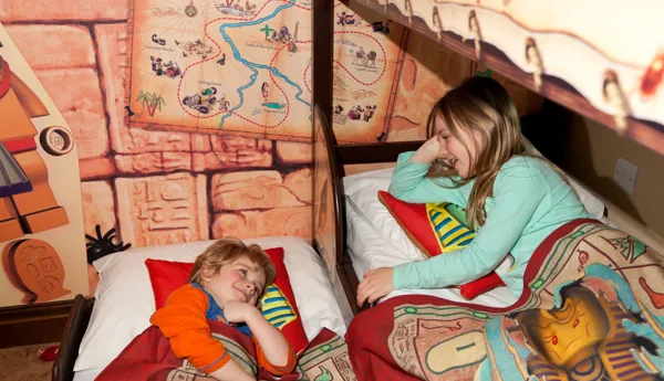 Boy and girl on bunk beds in an Adventure Room in the LEGOLAND Resort Hotel