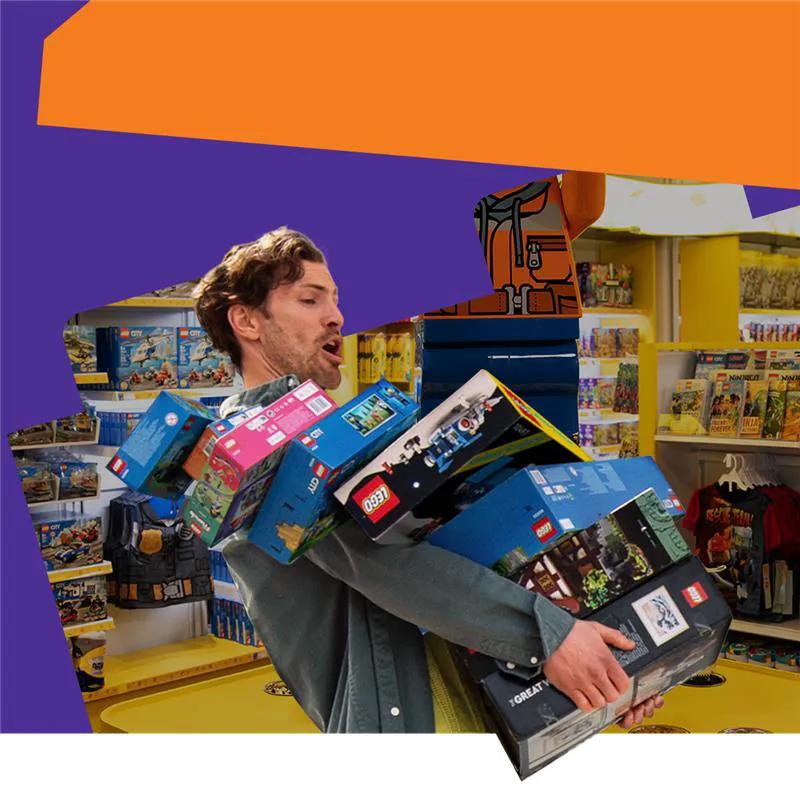 Gentleman carrying boxes of LEGO 