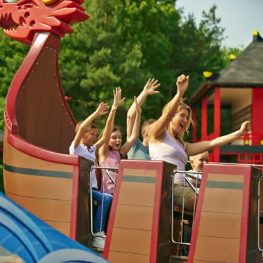 Family smiling with arms in the air on Destiny's Bounty