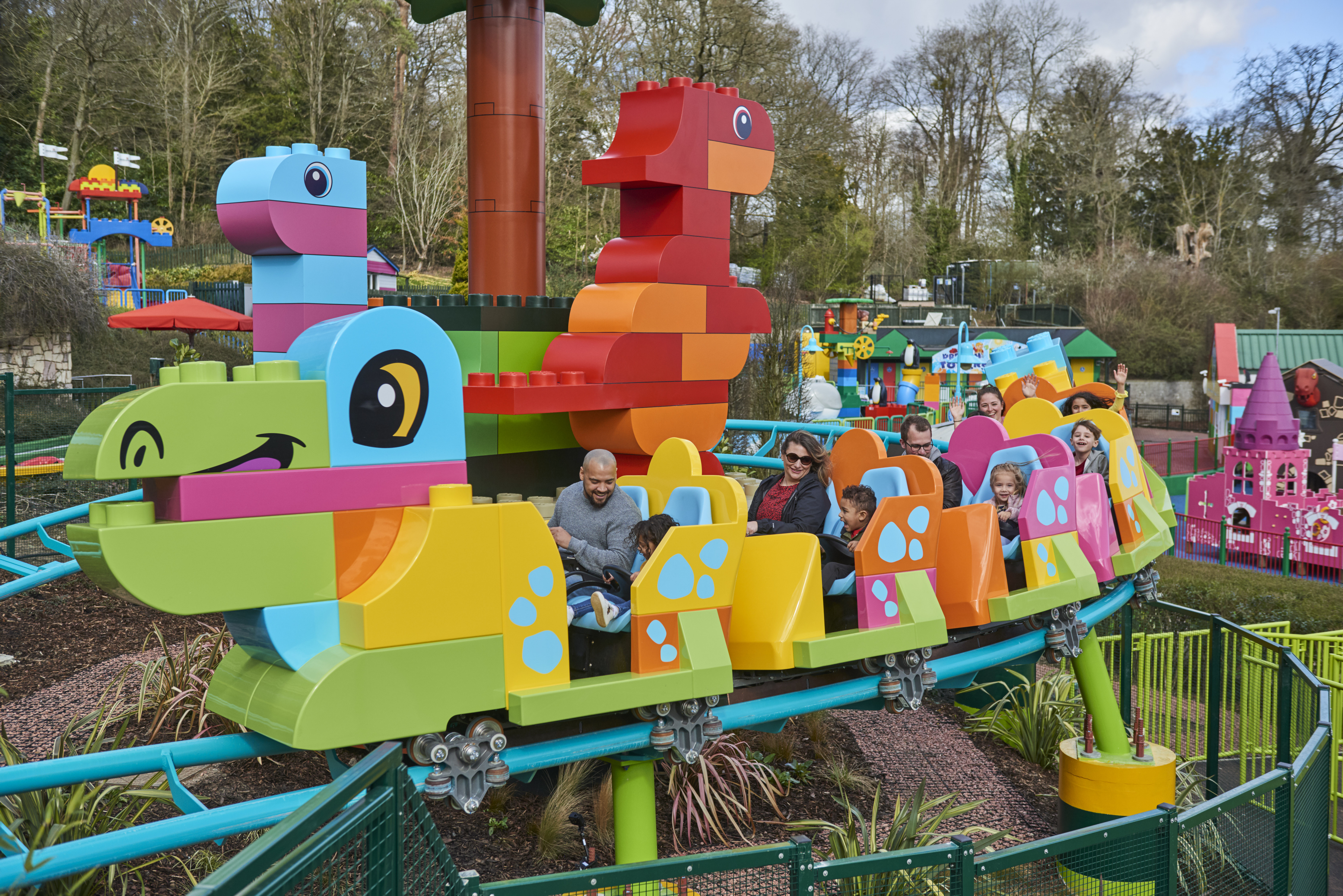 Families riding DUPLO® Dino Coaster at the LEGOLAND® Windsor Resort