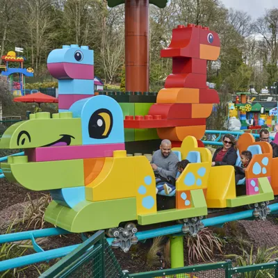 Families riding DUPLO® Dino Coaster at the LEGOLAND® Windsor Resort