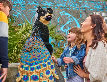 Family looking at Peadog in LEGO® MYTHICA at the LEGOLAND® Windsor Resort