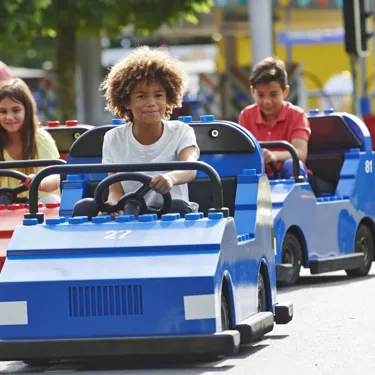 Children driving cars on LEGO® City Driving School at LEGOLAND® Windsor Resort