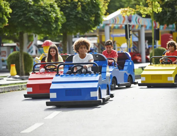 Children driving cars on LEGO® City Driving School at LEGOLAND® Windsor Resort
