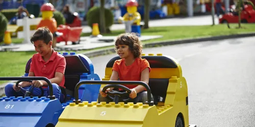 Boys driving cars at LEGO® City Driving School at LEGOLAND® Windsor Resort
