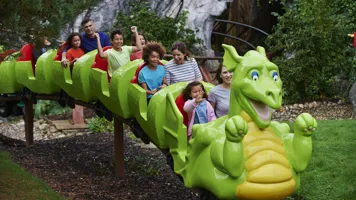 Families smiling on Dragon's Apprentice at the LEGOLAND Windsor Resort