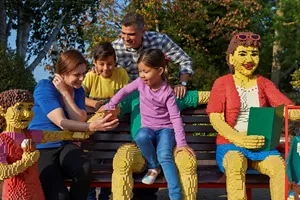 Family sat on bench using LEGOLAND Windsor app