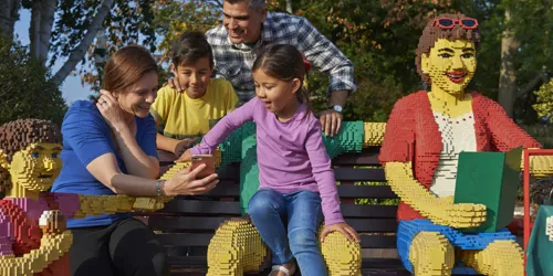 Family sat on bench using LEGOLAND Windsor app