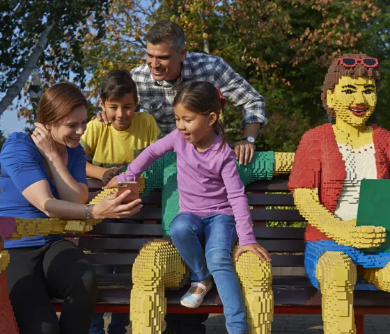 Family sat on bench using LEGOLAND Windsor app
