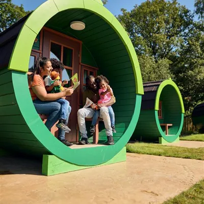 Family sat outside Woodland Village barrel