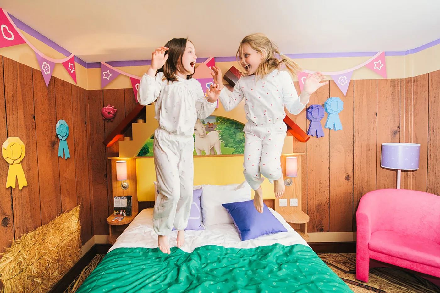 Children jumping on bed in LEGO Friends Room in the LEGOLAND Resort Hotel